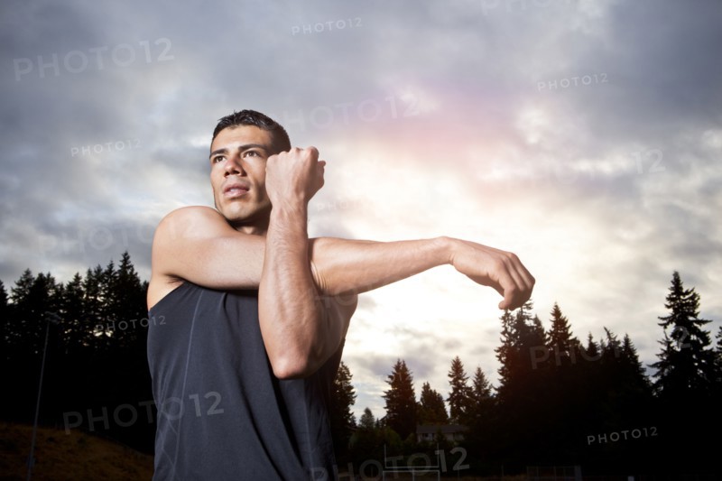 Hispanic man stretching before exercise