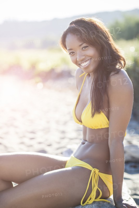 Mixed race woman in bikini on beach