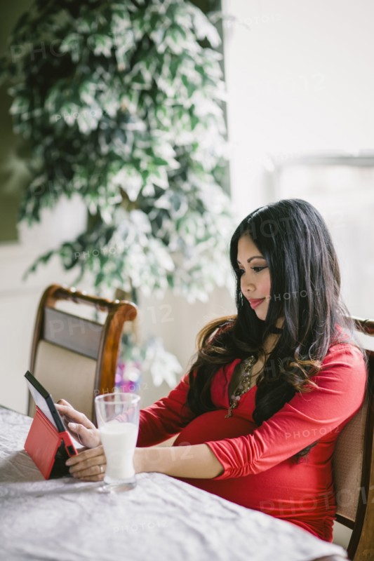 Pregnant Asian woman using digital tablet
