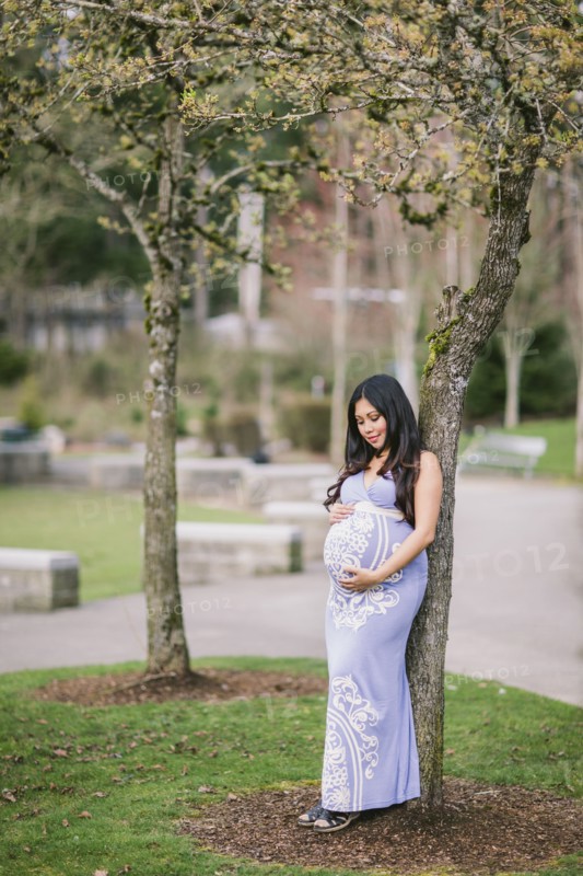 Asian woman holding her pregnant belly