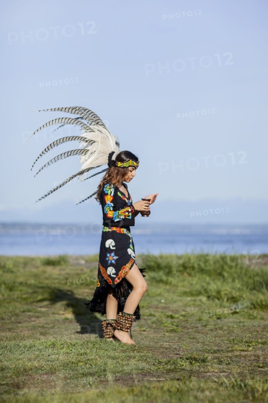 Native American woman in traditional headdress performing ceremony