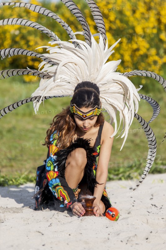 Native American woman in traditional headdress performing ceremony