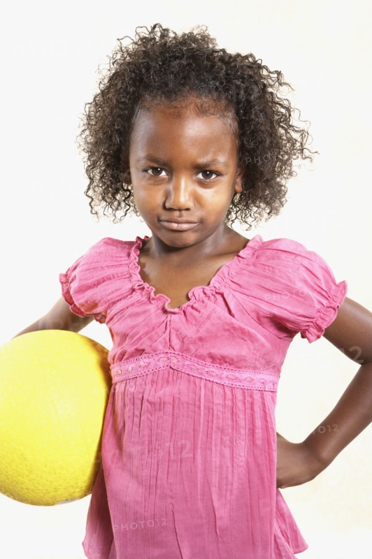 Studio shot of African girl holding ball