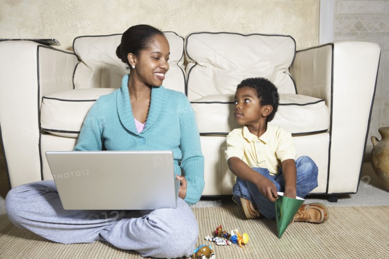 African American mother sitting with son and laptop