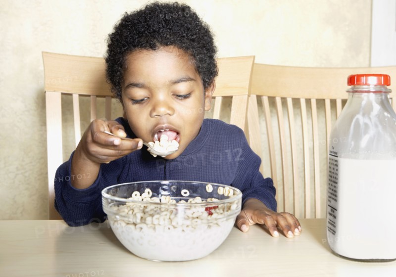 Young African American boy eating cereal