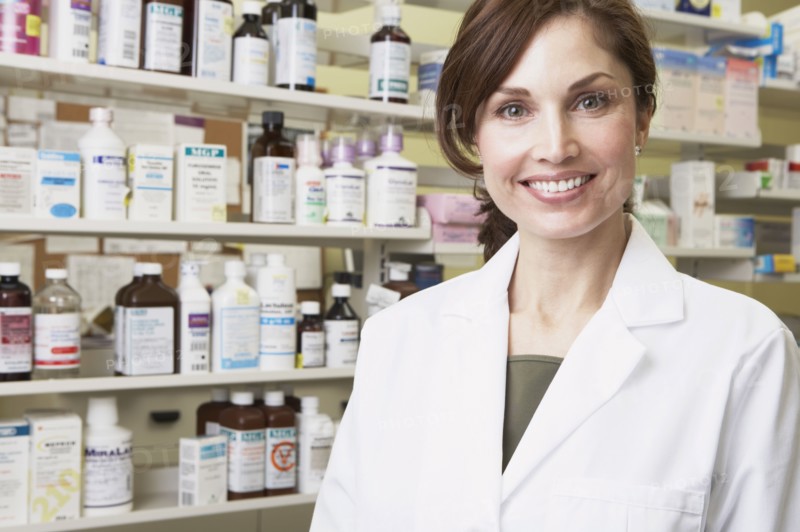 Female pharmacist smiling in pharmacy