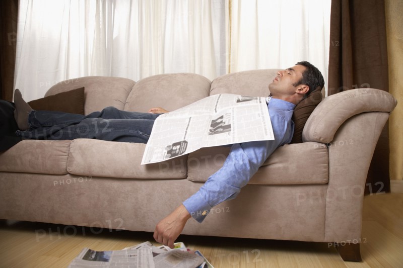 Hispanic man sleeping on sofa