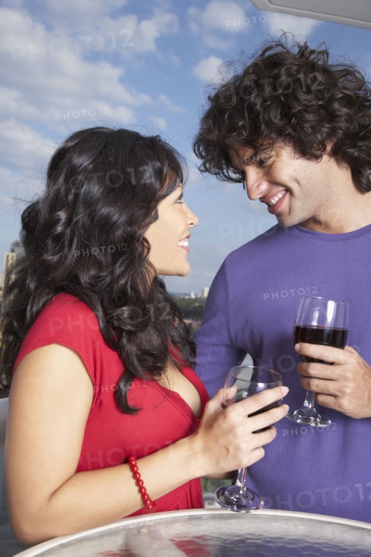 Hispanic couple smiling at each other