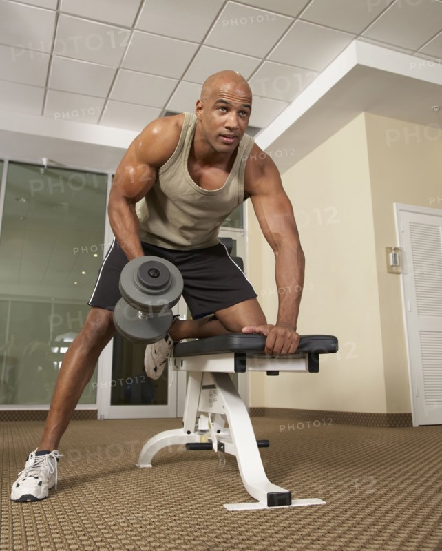 Mixed Race man lifting weights
