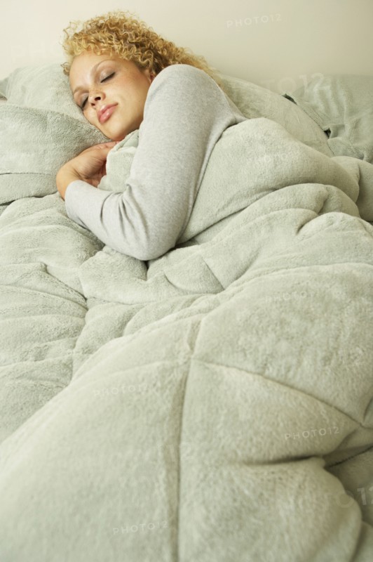 Young woman sleeping in bed