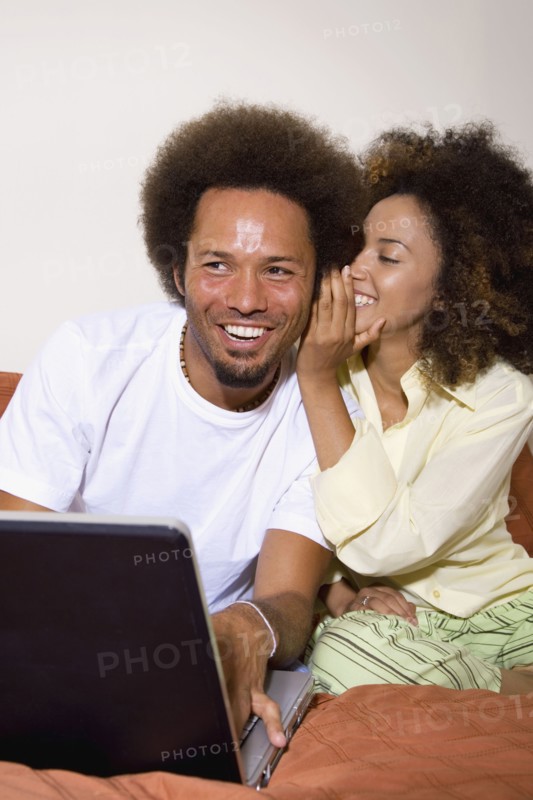 African couple telling secret