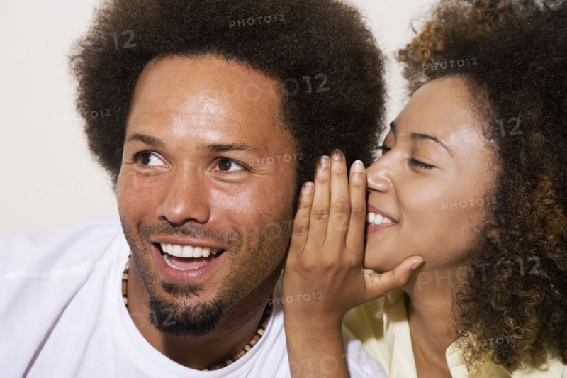 African couple telling secret