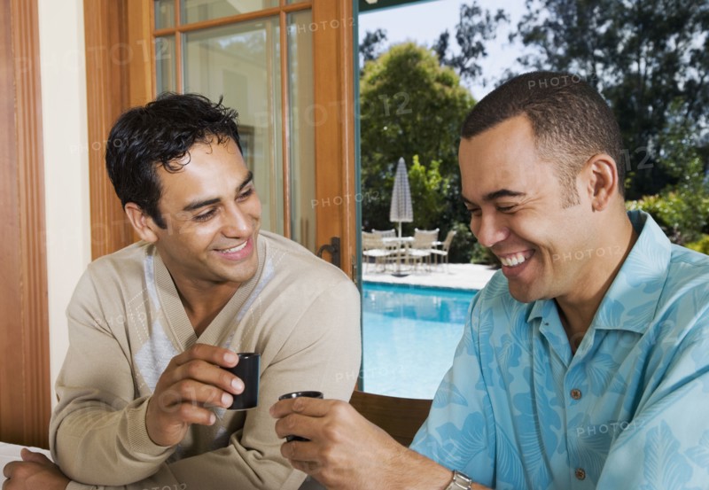 Multi-ethnic men toasting with sake