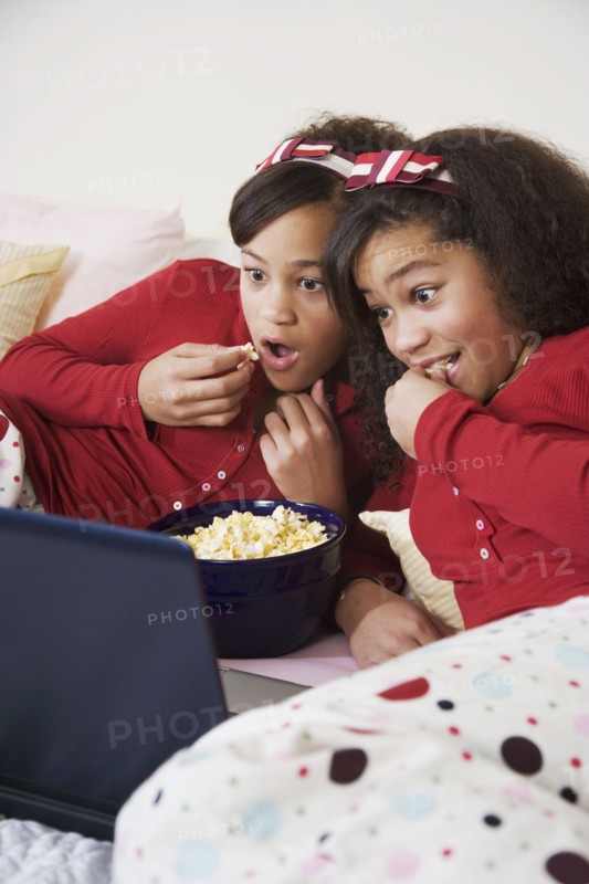 African twin sisters watching movie