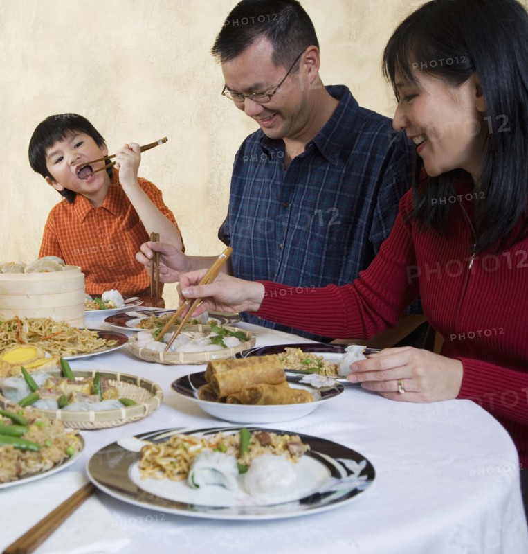 Asian family eating at dinner table