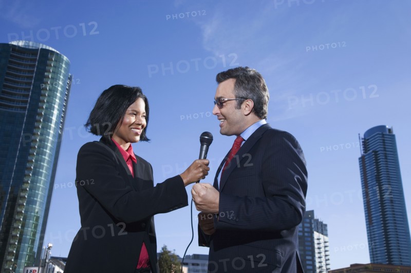 African female reporter interviewing businessman