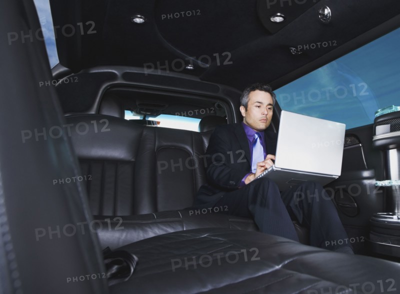 Hispanic businessman typing on laptop