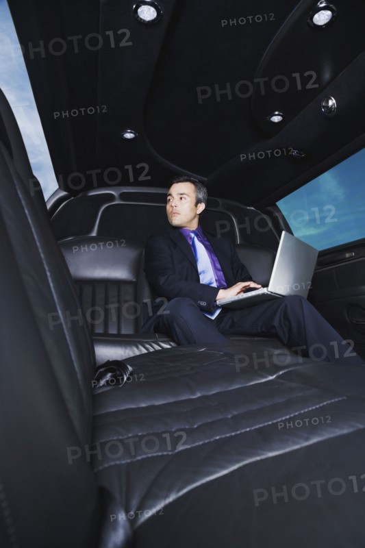 Hispanic businessman typing on laptop