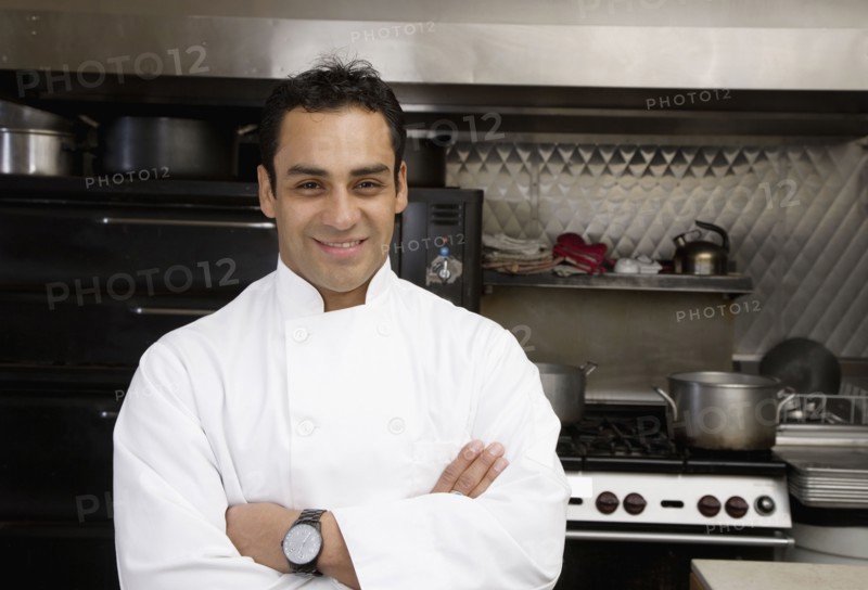 Hispanic male chef with arms crossed