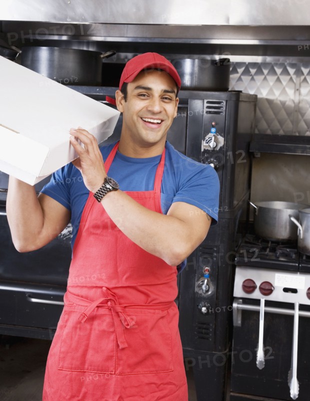 Hispanic male pizza maker holding box