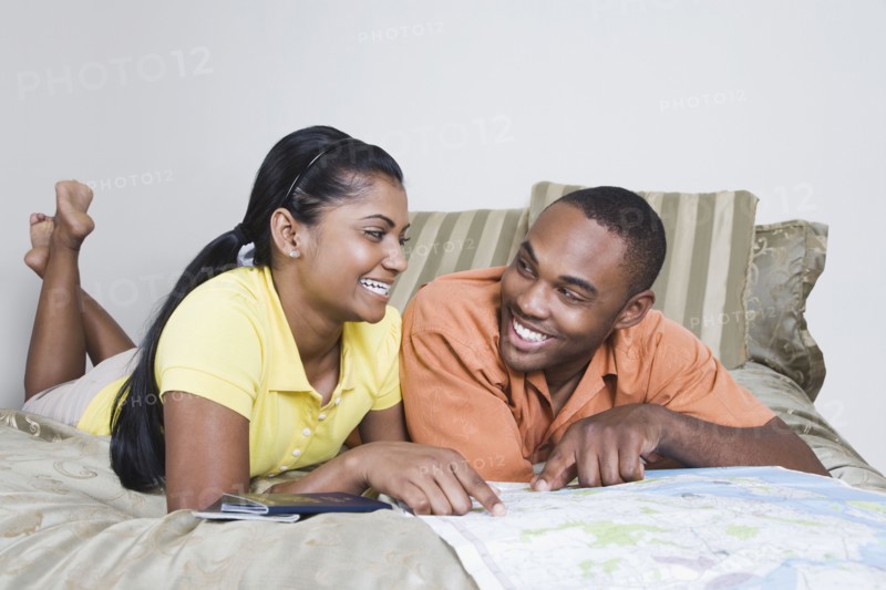 Multi-ethnic couple looking at map