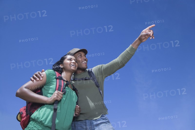 Multi-ethnic couple backpacking