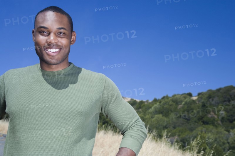 Mixed race man standing in rural area