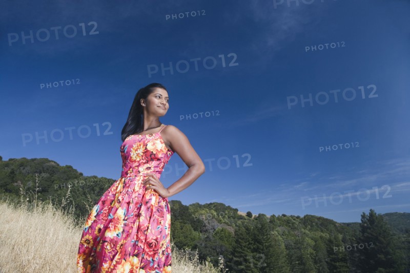 Mixed race woman in sundress in rural area