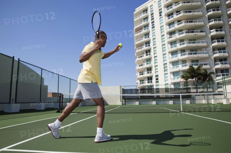 African man playing tennis