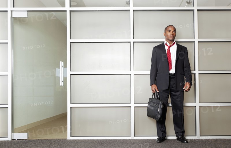 Mixed race businessman standing in modern office