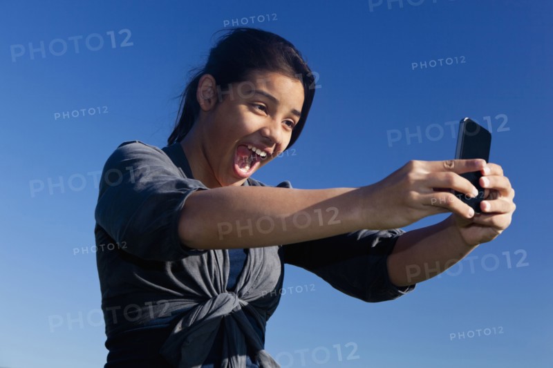 Hispanic teenage girl taking picture