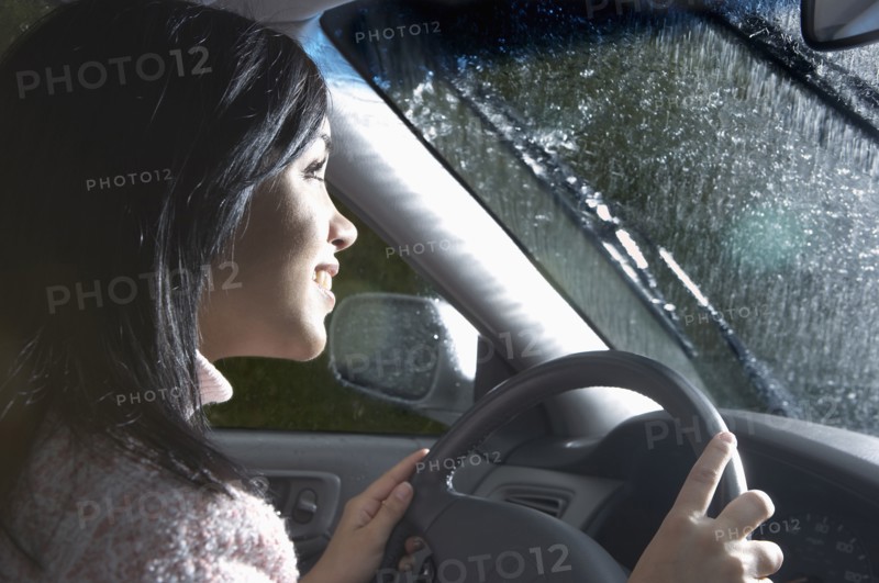 Indian woman driving in heavy rain