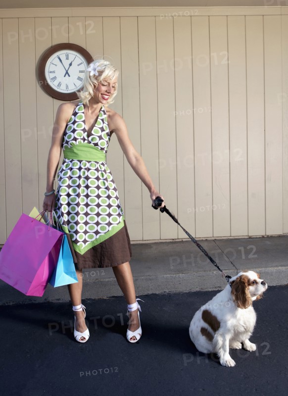 Caucasian woman with dog on sidewalk