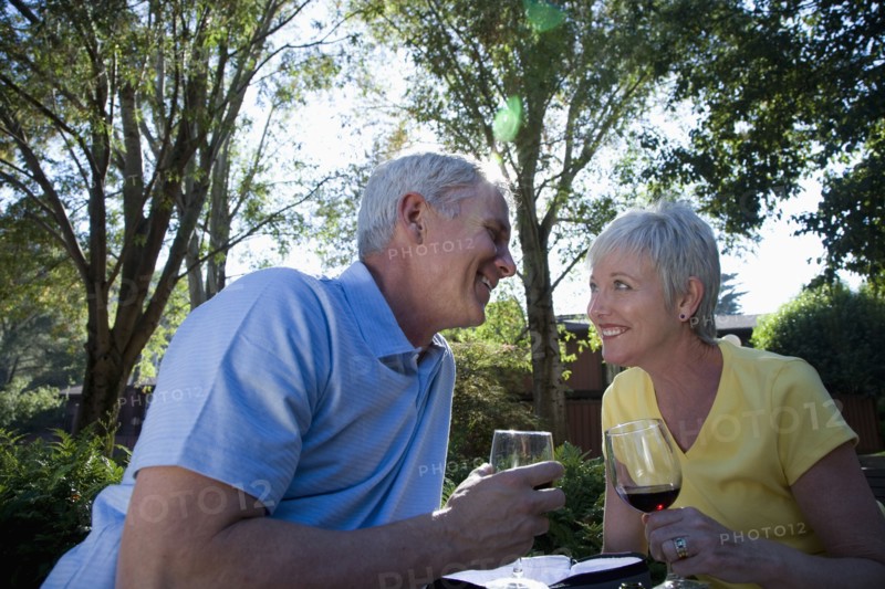 Senior Caucasian couple drinking wine outdoors