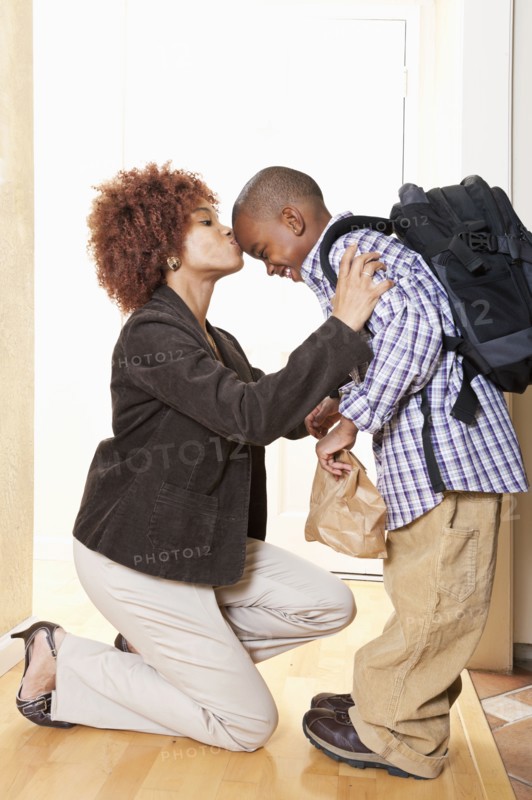 African American mother getting son ready for school