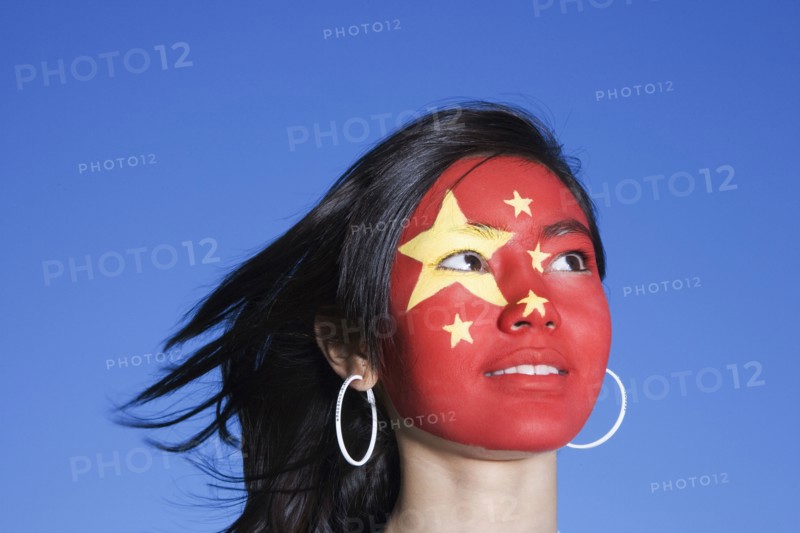 Chinese girl with Chinese flag painted on face