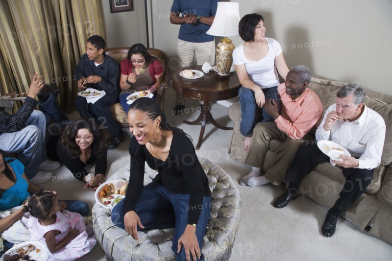 Multi-generation family relaxing together in living room