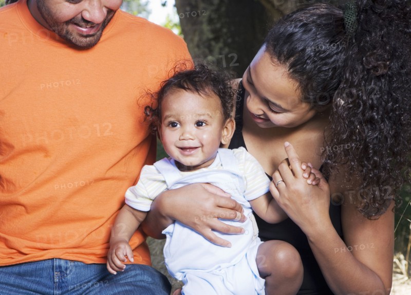 Couple holding baby outdoors