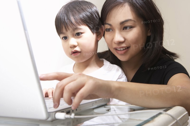 Filipino mother and son using laptop together