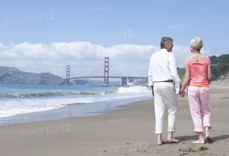 Senior Caucasian couple walking by Golden Gate Bridge