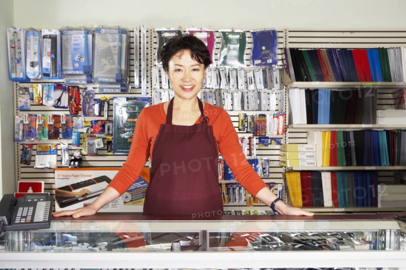 Chinese woman working in office supply store