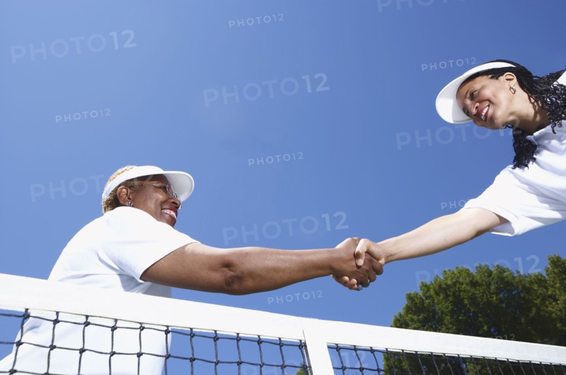 Tennis players shaking hands at net
