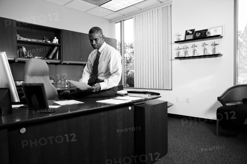African American businessman sitting on desk