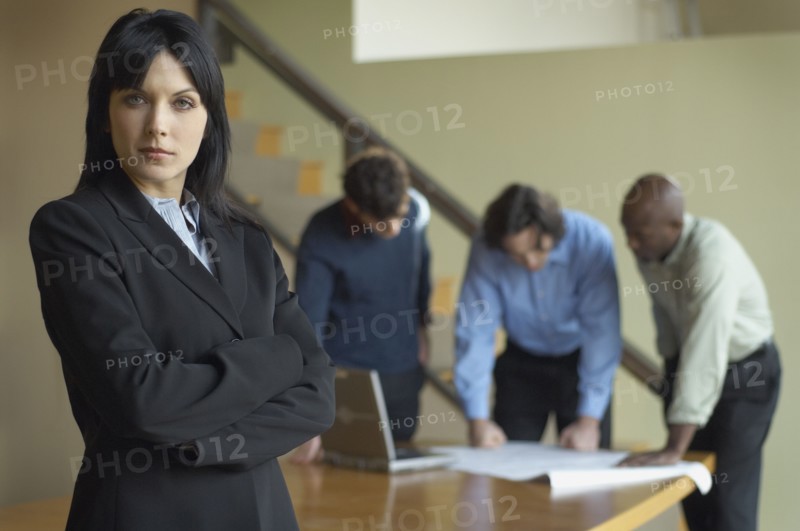 Portrait of businesswoman with coworkers in background