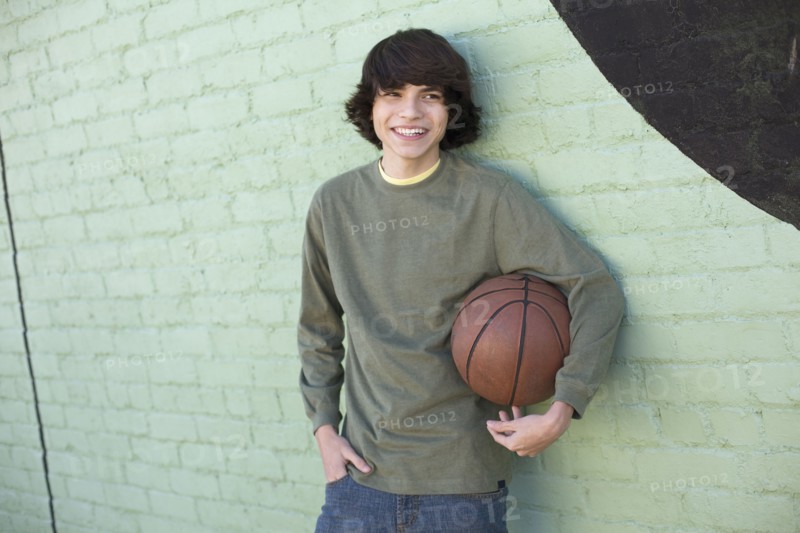 Hispanic boy holding basketball