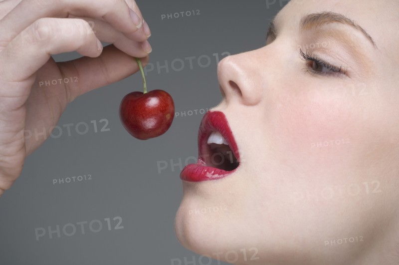Woman eating cherry