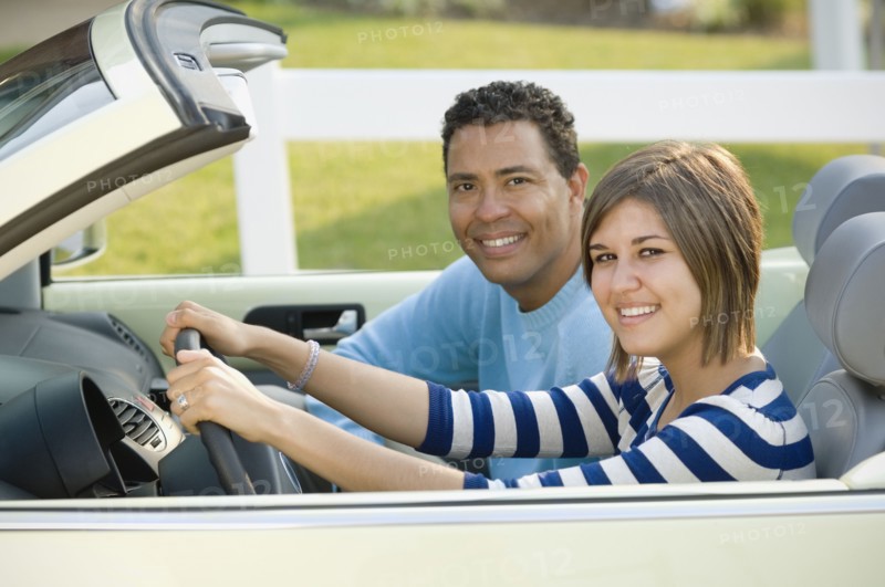Hispanic father and daughter in car