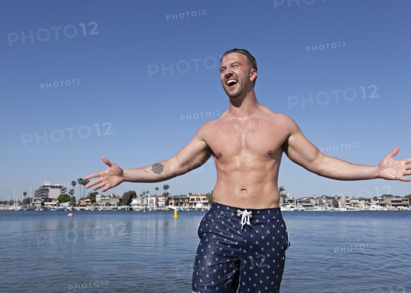 Caucasian man wearing swimsuit on beach