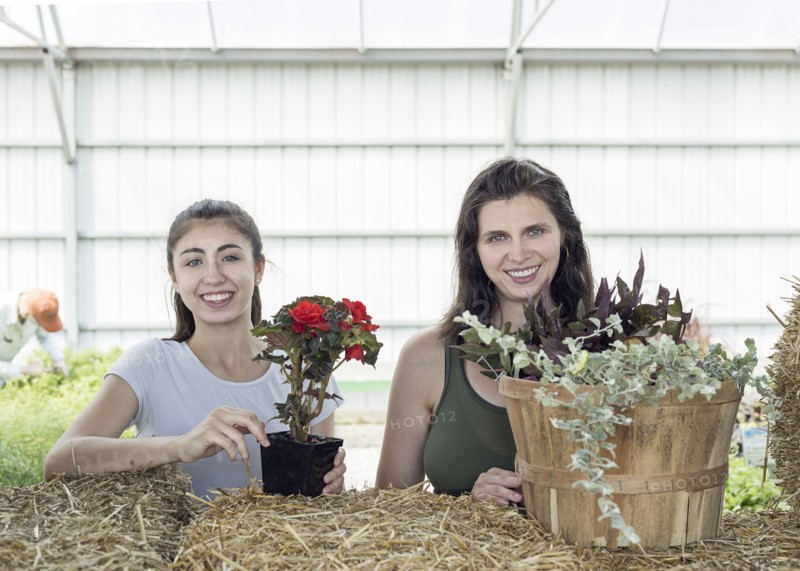 Portrait of Caucasian mother and daughter holding flowers