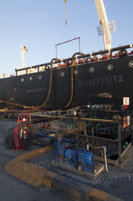 Oil tanker ship docked in industrial harbor